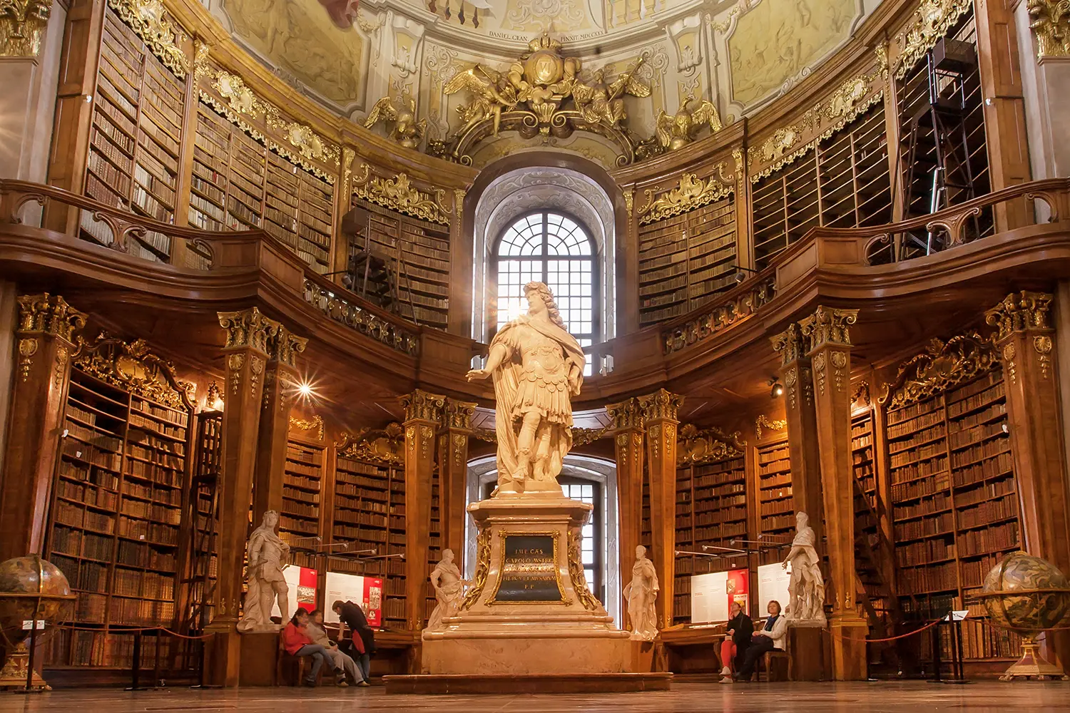 Antique sculpture in interior of old books of the Austrian National Library in Vienna, Austria